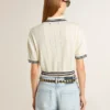 Women's cropped worn-white cotton polo shirt with blue ribbing