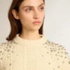 Women's cropped worn-white sweater with decorative crystals