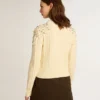 Women's cropped worn-white sweater with decorative crystals