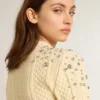 Women's cropped worn-white sweater with decorative crystals