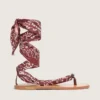 Women’s flat sandals with burgundy paisley pattern and jewel detail