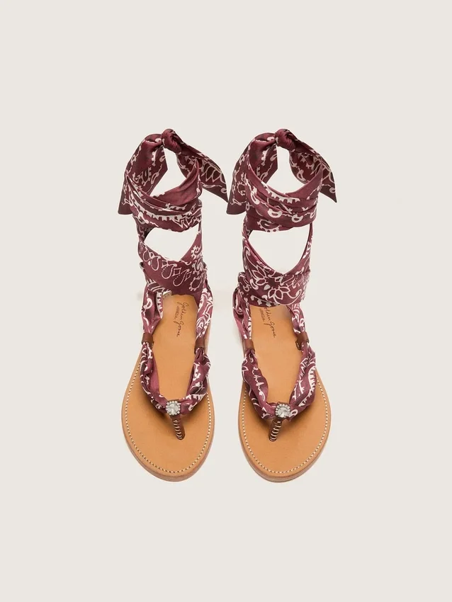 Women’s flat sandals with burgundy paisley pattern and jewel detail