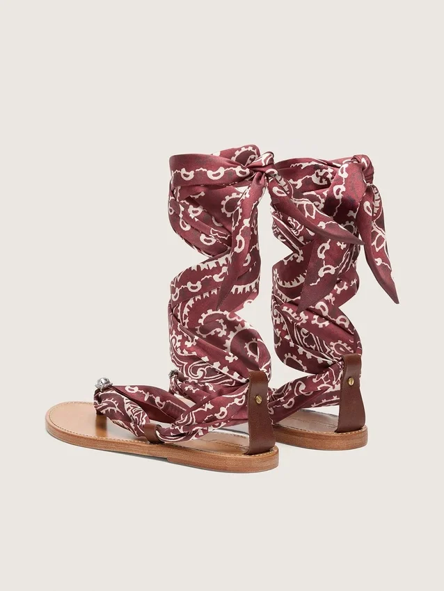 Women’s flat sandals with burgundy paisley pattern and jewel detail