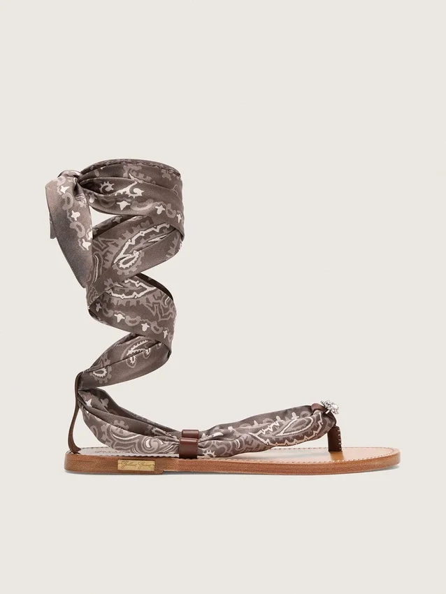 Women’s flat sandals with gray paisley pattern and jewel detail