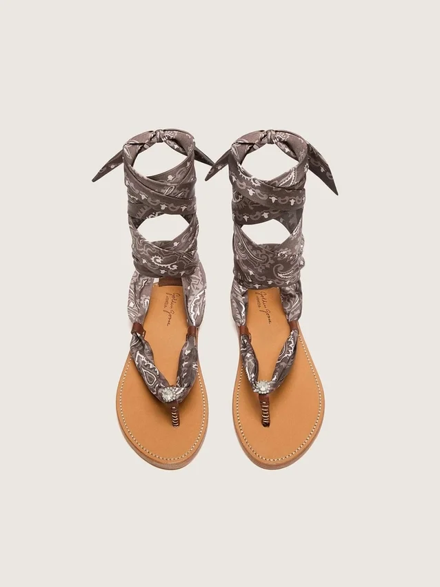 Women’s flat sandals with gray paisley pattern and jewel detail