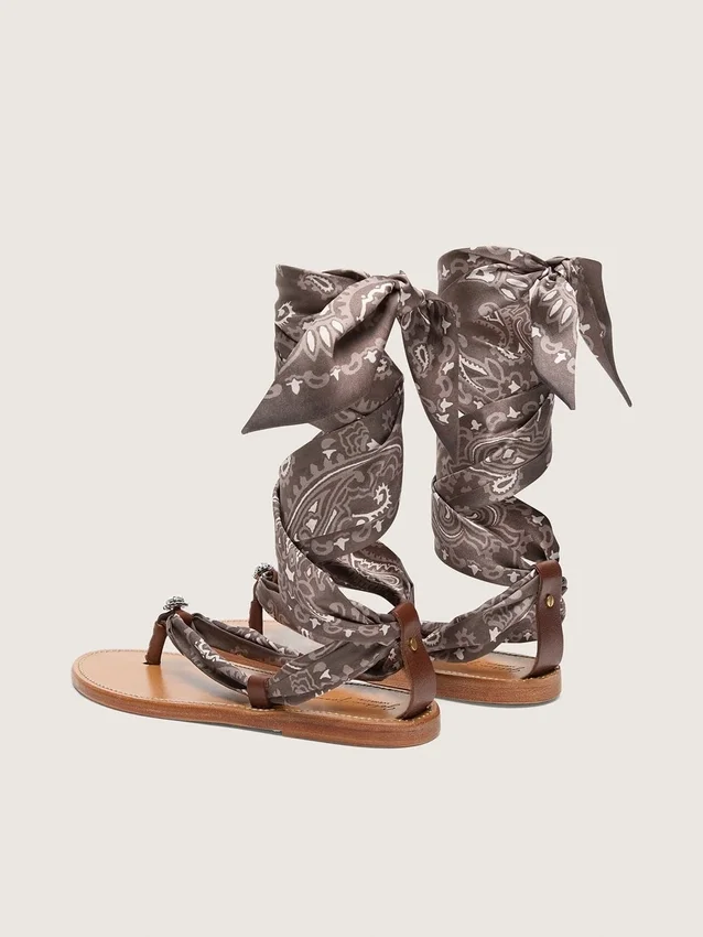 Women’s flat sandals with gray paisley pattern and jewel detail