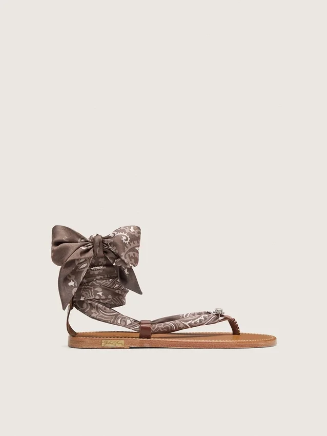 Women’s flat sandals with gray paisley pattern and jewel detail