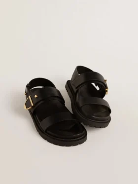 Women’s Lucy sandal in glossy black leather with gold metal buckle