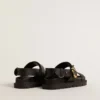 Women's Lucy sandal in glossy black leather with gold metal buckle