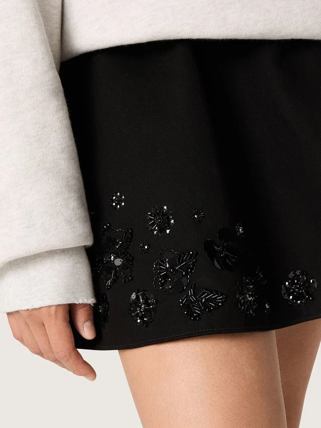 Women’s miniskirt in black cotton twill with floral sequin embroidery