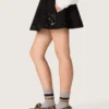 Women’s miniskirt in black cotton twill with floral sequin embroidery