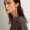 Women's single drop earring in antique gold color with decorative crystals