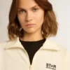 Women’s white zipped sweatshirt with white strip and black stars