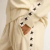 Women’s white zipped sweatshirt with white strip and black stars
