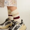 Worn-white socks with distressed details and beige and burgundy stripes