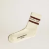 Worn-white socks with distressed details and brown stripes