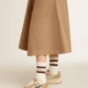 Worn-white socks with distressed details and brown stripes