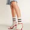 Worn-white socks with distressed details and brown stripes