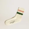 Worn-white socks with distressed details and pink and green stripes