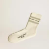 Worn-white socks with distressed details and sage-green stripes