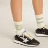 Worn-white socks with distressed details and sage-green stripes