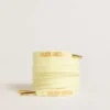 Yellow cotton laces with contrasting gold-colored logo