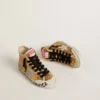 Young Francy Penstar in gold sequins with ice-gray suede star
