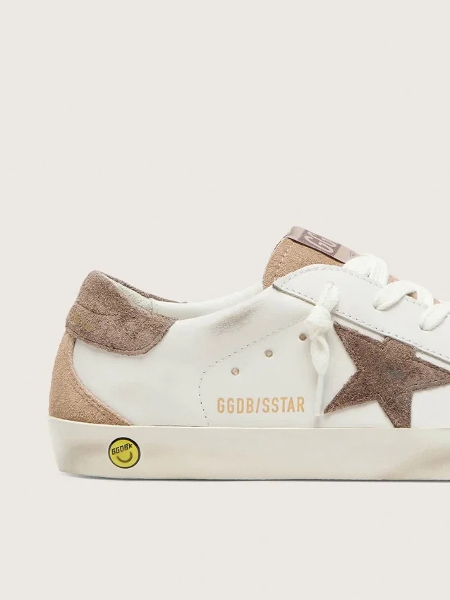 Junior Super-Star in white leather with dark gray suede star and beige suede inserts